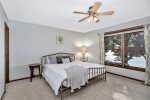 Primary bedroom with a king size bed and ensuite bathroom